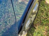 a close up of a car ' s tire with grass on the ground
