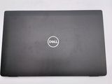 the dell laptop is sitting on a table with its lid open