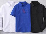 three men ' s shirts in different colors on a gray background