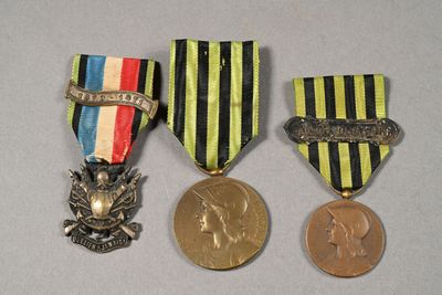 three medals and a coin sitting on top of a table