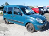a small blue van that is parked in a lot