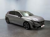 the silver car is parked in a room with a white wall