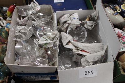 a box full of empty wine glasses on a table