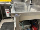 a stainless steel sink in a commercial kitchen