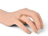 someone is wearing a gold ring on their left hand