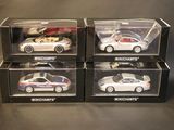 three boxed boxes of toy cars on a table with a black background