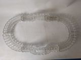 a clear glass bracelet that has been placed on a table