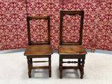 two wooden chairs sitting next to each other on the floor