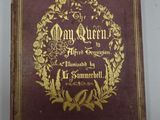 an old book with gold lettering on it sitting on a table