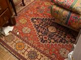an image of a living room with a rug on the floor