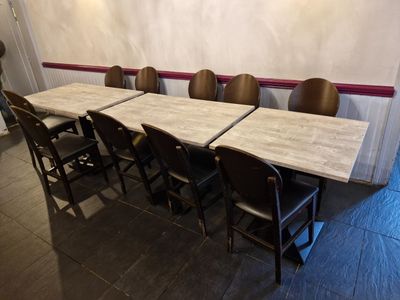 Dans un restaurant, les tables et les chaises sont alignées en rangée.