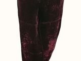 the woman is wearing a pair of velvet pants and a black top
