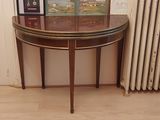 a small table with a picture on it next to a radiator