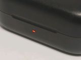 a black case with a red button on it