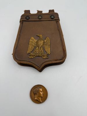 an image of a medal with a coin in front of it