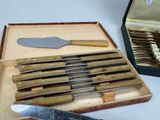 a box of knives and a knife sharper on a table