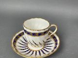 a close up of a cup and saucer on a table