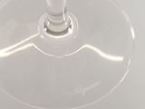 a wine glass with a red liquid inside of it