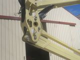 a yellow crane that is sitting in front of a building