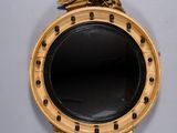 a gold mirror with an eagle on top of it
