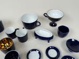 a lot of cups and saucers on the table