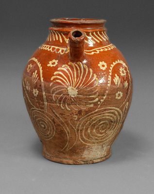 an image of a brown vase with white designs on it