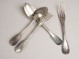 a spoon, fork, and spoon rest on a table