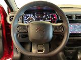 the interior of a car with a steering wheel and dashboard controls