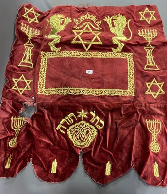 a red velvet table cloth with a gold border and a golden star of david on it