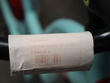 a roll of paper on the handlebar of a bicycle