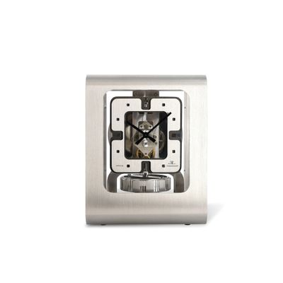 a silver clock that is on a white surface