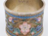 a gold ring with blue and pink flowers on it