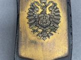 a black leather belt with a gold eagle on it