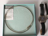 a watch and a bracelet in a box on a table