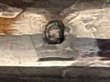 a silver plate with a bird on it on a table