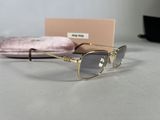 sunglasses with gold frames and a pink case on a table