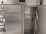 an empty refrigerator in the middle of a kitchen
