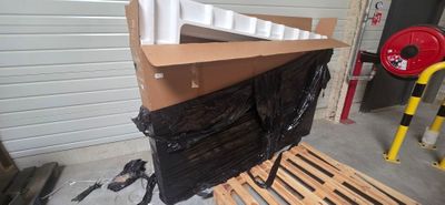 boxes and pallets are stacked on top of a pallet in a garage