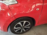 a red car that is parked in a garage