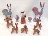 many figurines of animals that are sitting on a table