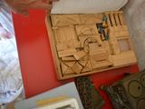 a person that is making a wooden model of a house