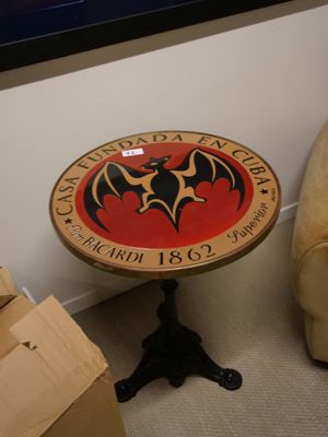 une petite table sur laquelle repose une batte, dans un coin de la pièce