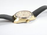 a watch that is laying on a white surface