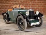 a vintage car parked in front of a brick wall