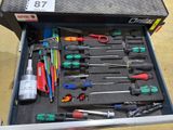 many tools in a tool box on the floor
