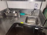 a kitchen with a sink, stove, and counter top