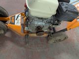 a small lawn mower that is sitting on the ground