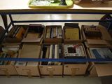 many boxes of books sitting on a table in a room