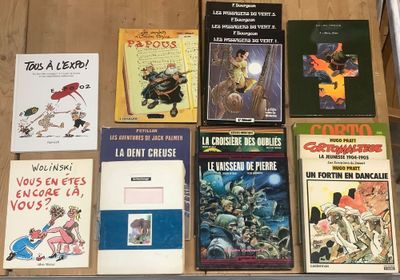 several books are on a table in front of a laptop computer