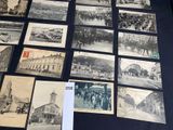 several old black and white photographs of people and buildings on a table